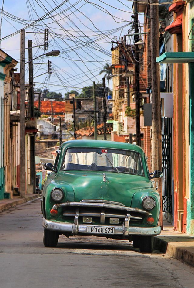 A car is parked on a colorful urban street