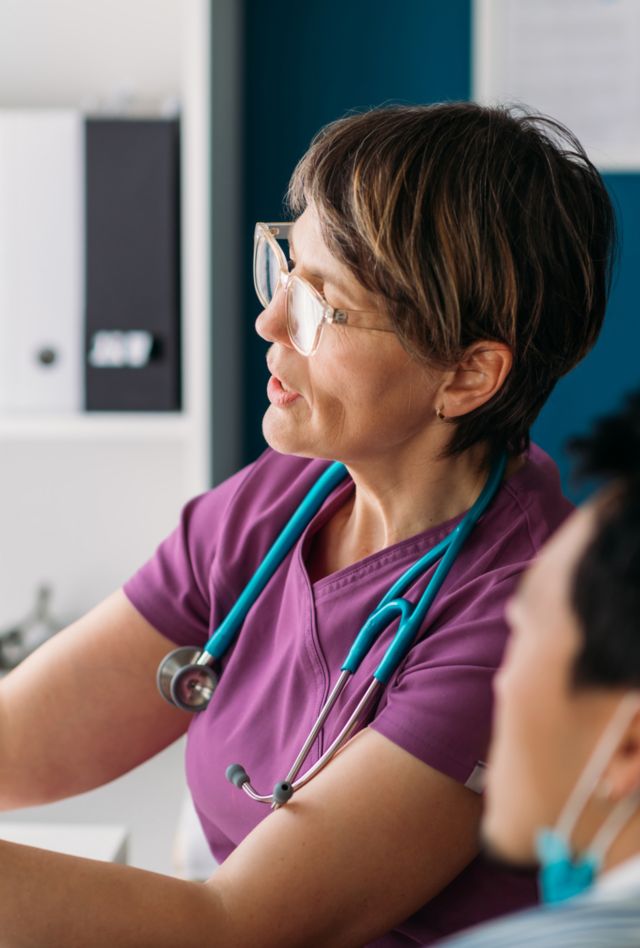 Doctor specialist interpreting x-ray image to her patient