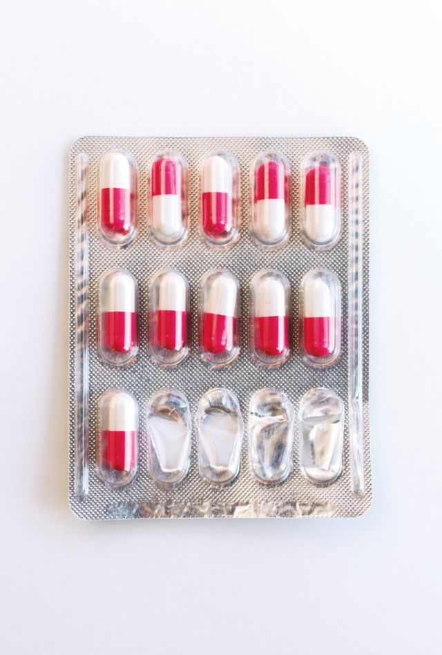 a foil package of pill capsules with some pills missing