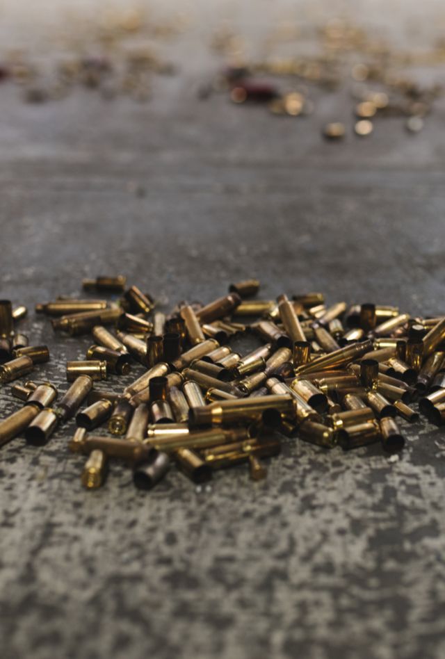 Close up of spent gun casings on the ground