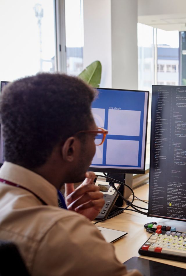 two men looking at computer screen in the office
