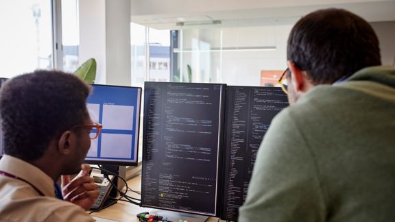 Big data analysts looking at computer screen in the office