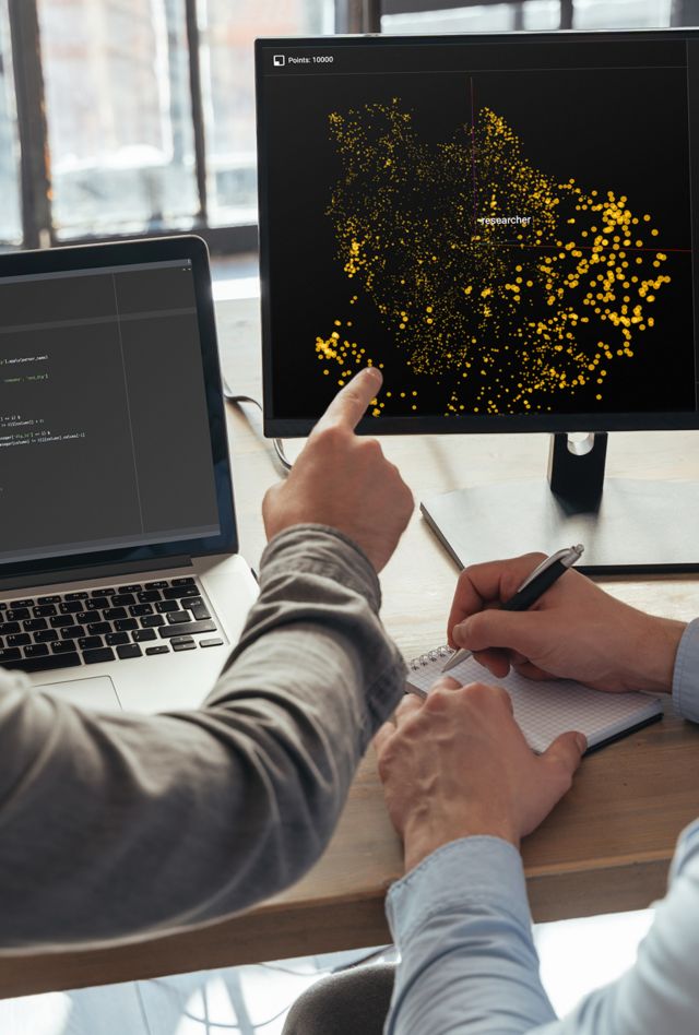 Closeup of two men data science specialists working at office together, analyzing big data on screen. Coders working on new project