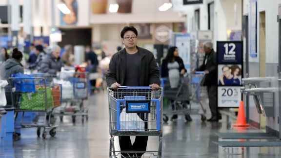 A man pushes a cart while shopping at a Walmart store, Thursday, Nov. 9, 2017, in North Bergen, N.J. (AP Photo/Julio Cortez)
