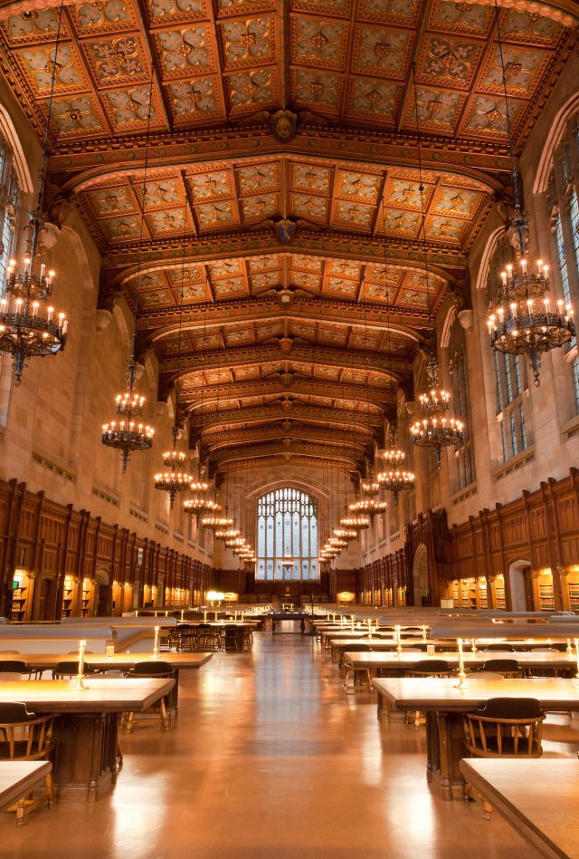 Interior of large, Gothic library with long rows of tables