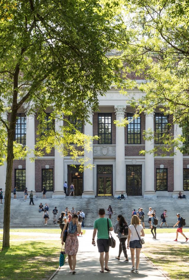 2HNRR90 Students and tourists rest in lawn chairs in Harvard Yard, the open old heart of Harvard University campus