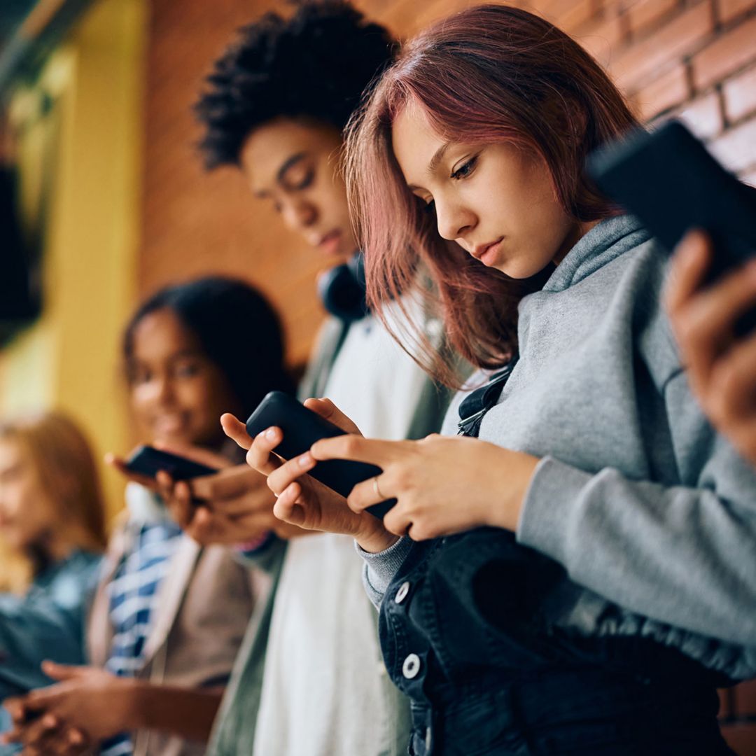 Young people looking at mobile phones