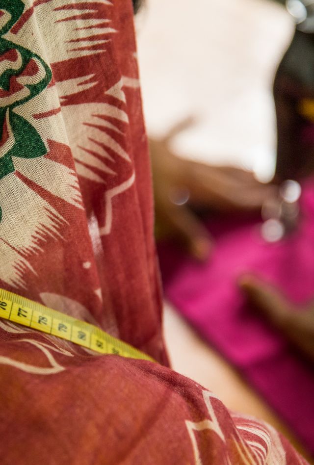 A Bangladeshi woman practices sewing for the first time. She was taken off the streets and given a skill to have a future.