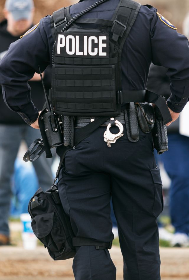 A police officer watches protesters