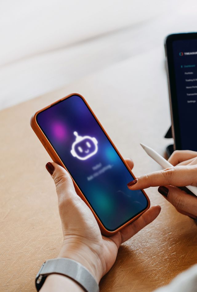 Person using AI chatbot virtual assistance app on smartphone