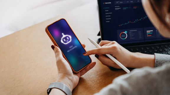 Person using AI chatbot virtual assistance app on smartphone