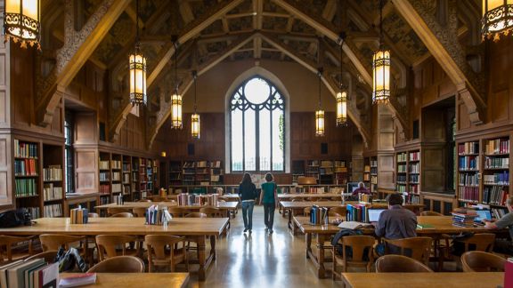 Wide view of a large hall in a gothic university library 