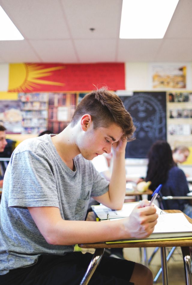 High school students at desks in classroom