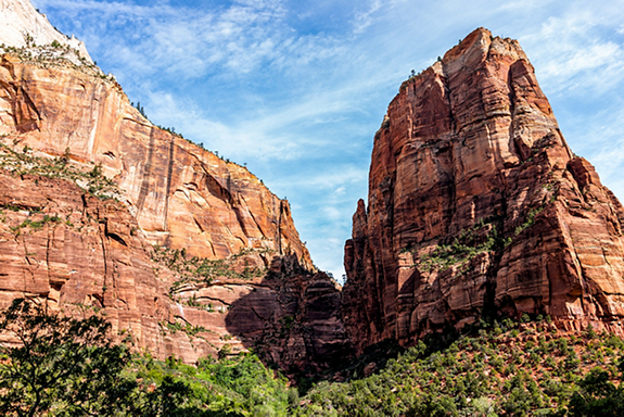 Low angle view of red orange Zion National Park Angel's Landing cliffs desert landscape during summer day with tall high rock formations