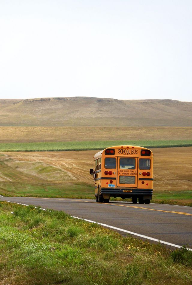 2BATFDW School Bus in a lonely empry road near Bismarck in North Dakota, USA