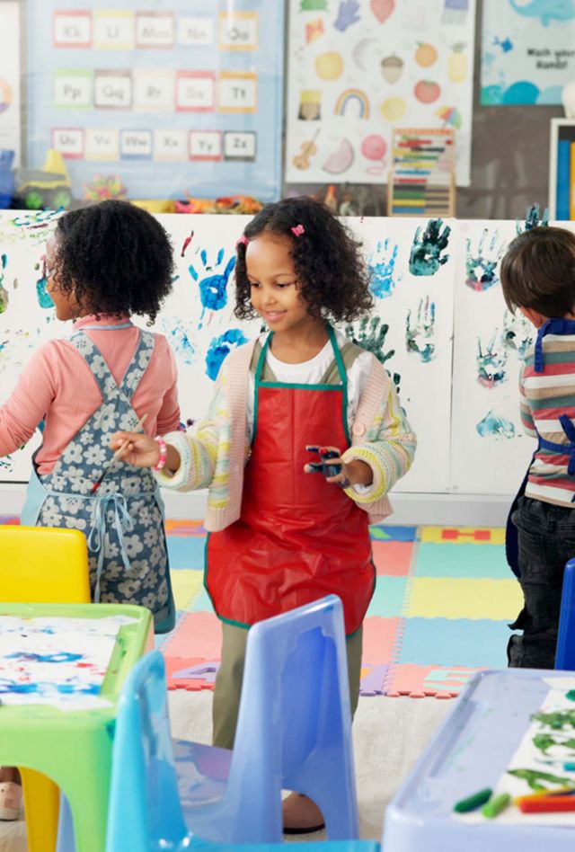Handprint, painting and children with paper in classroom for creative lesson, education and development. School, students and kids learning with colors for fun activity, art project and motor skills