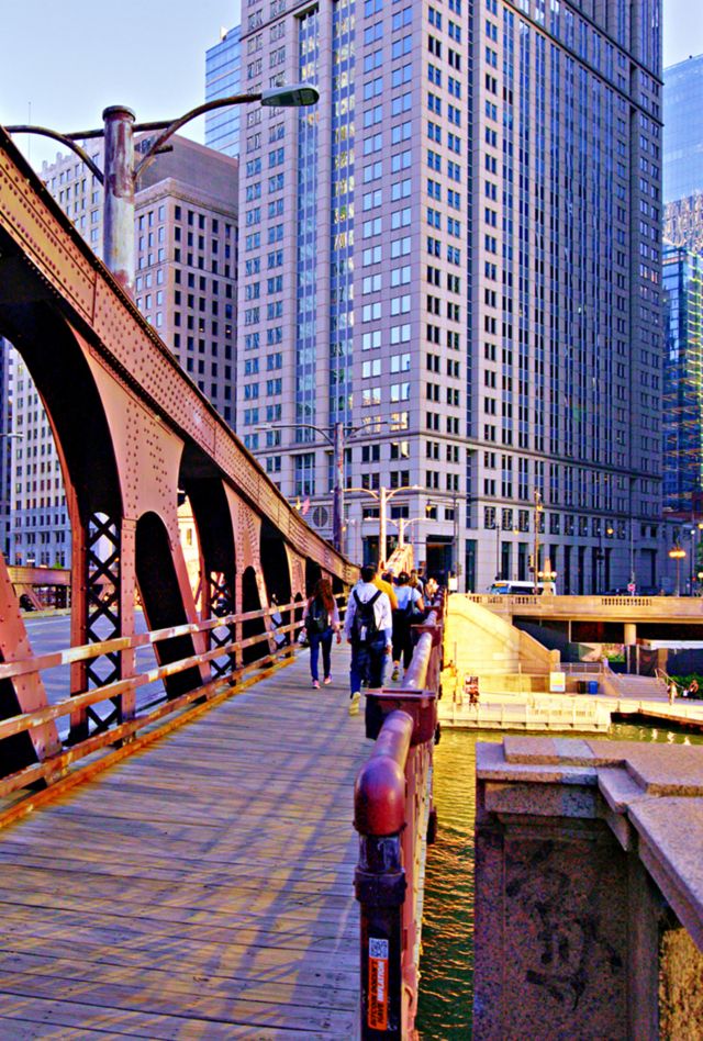 People walking across bridge in Chicago