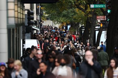 People walk the sidewalk in Chicago, United States on October 14, 2022. (Photo by Jakub Porzycki/NurPhoto via Getty Images)