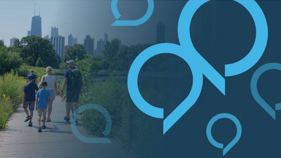 People walking on a path in a park with the Chicago skyline in the background. The image features a blue overlay with translucent blue speech bubble graphics.