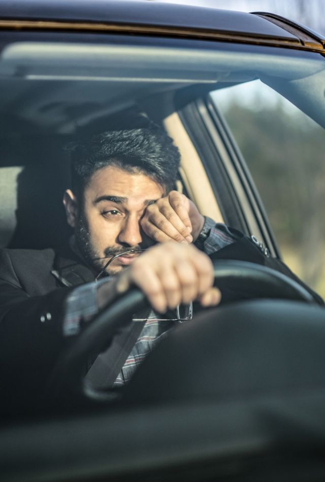 Middle Eastern man having bad eyesight, making effort to see the road.