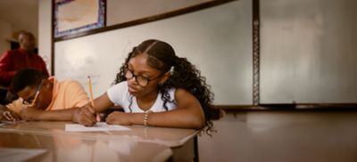 Junior-high Black students attend a math class at school.  They participate in math lesson and solve math problems.