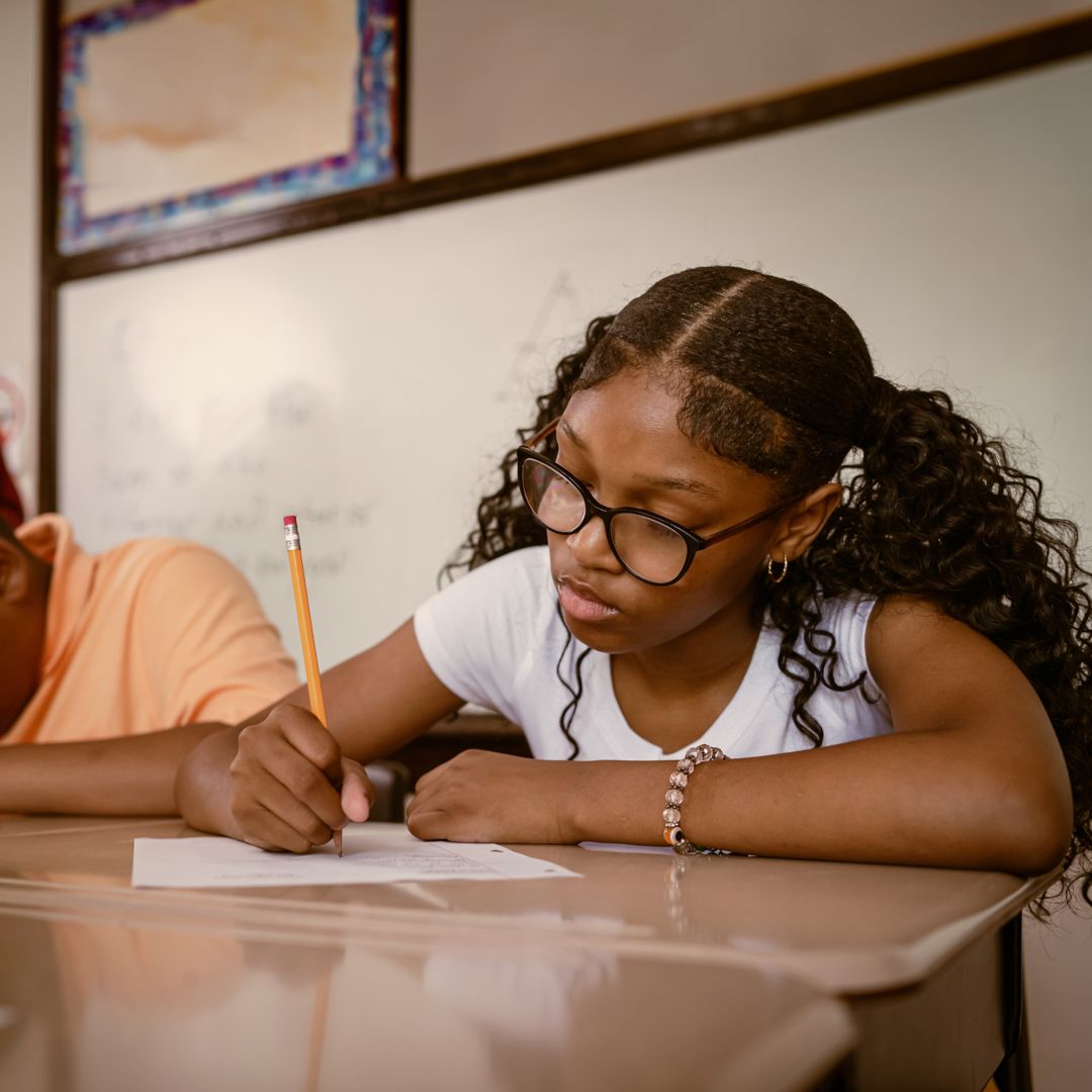 Junior-high Black students attend a math class at school.  They participate in math lesson and solve math problems.