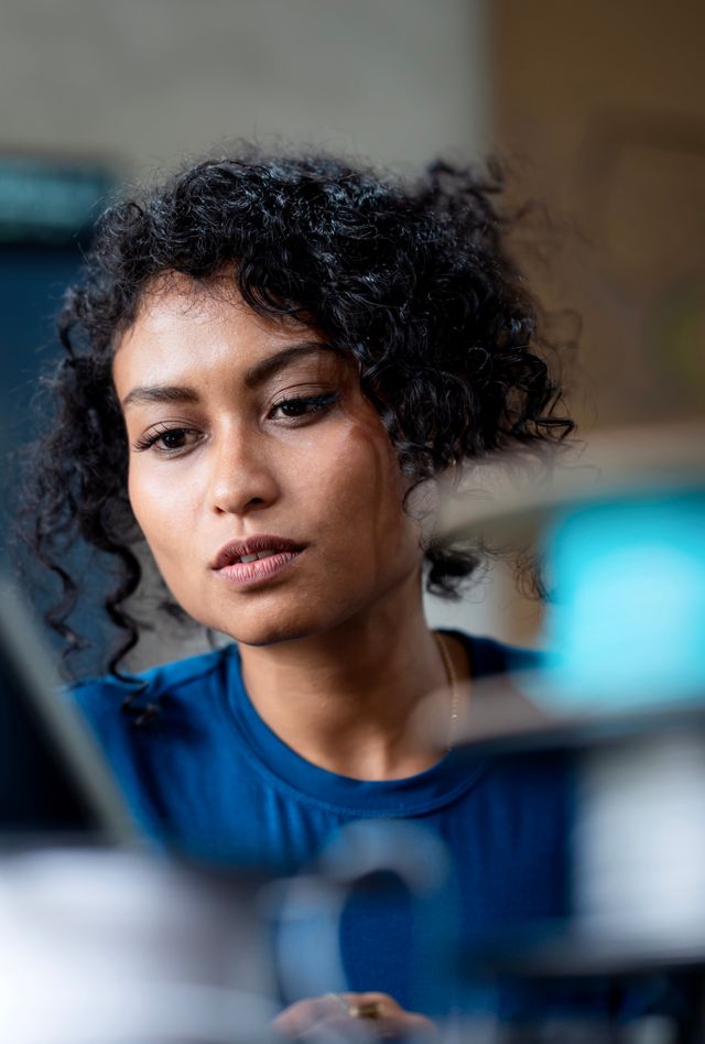 Data Analysis and Protect Insights to Improve Your Business Process with Software Development.  A female software engineer on software  project development to analyzing and ensuring reliability in a tech business office.