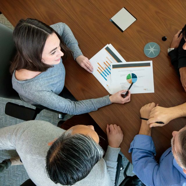 View from above of people reviewing a report.