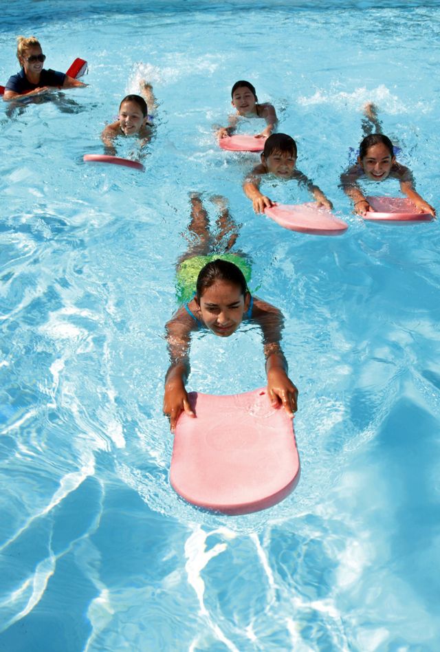 Children using floating devices in a swimming pool