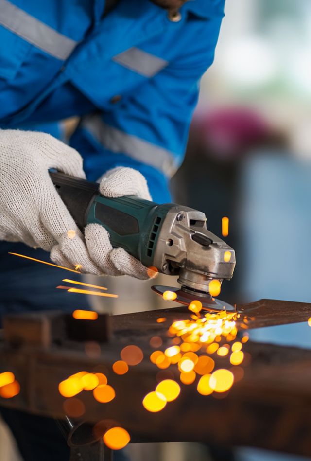 Workers were grinding steel inside the workshop until it sparked.