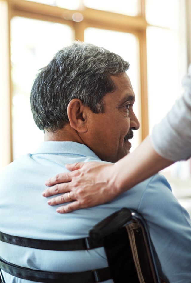 Shot of a young nurse caring for a senior man in a retirement home