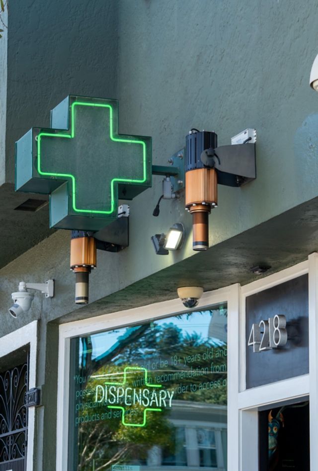 Green cross sign outside of a marijuana dispensary