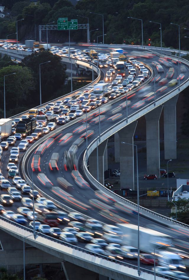 A traffic jam on a freeway at rush-hour. The stretch of highway is a raised overpass near central Auckland. Road congestion is a major issue for Auckland city.