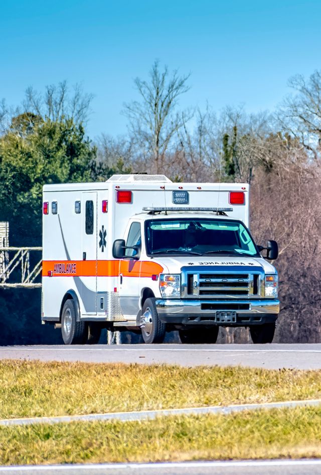 Horizontal shot of a generic ambulance on a roadway.