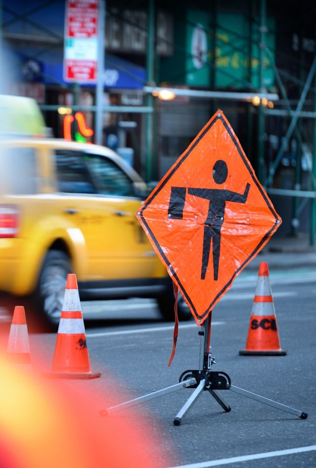 City street with a roadwork sign and traffic cones