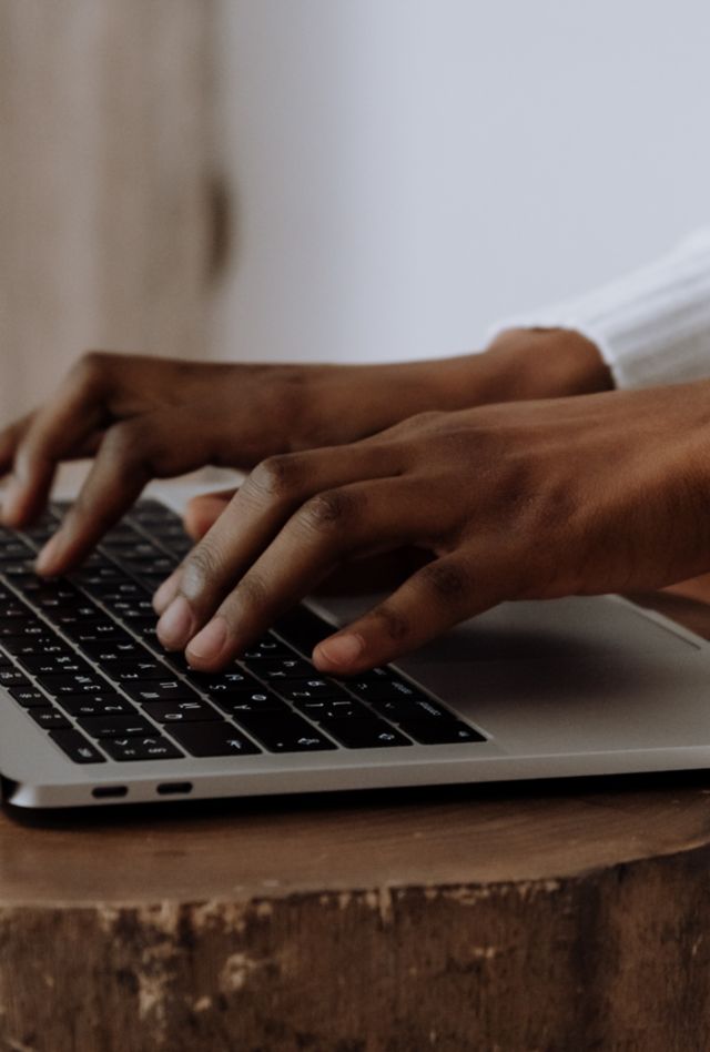 Fingers typing on a laptop keyboard