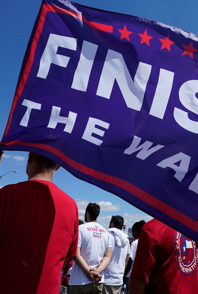 A participant holds a "Finish The Wall" flag at a March to the Border Rally, Saturday, Sept. 25, 2021, in McAllen, Texas. (AP Photo/Eric Gay)