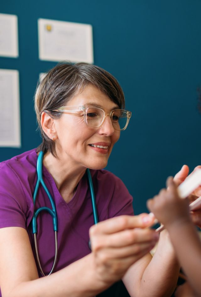 Health care provider with a little boy during a checkup