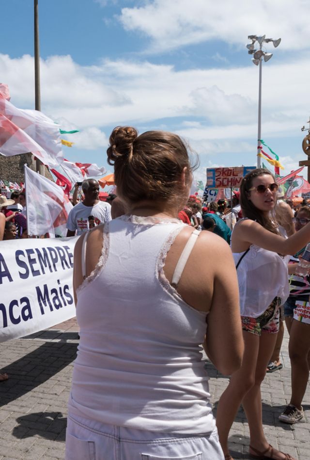 People at a protest holding signs in Spanish