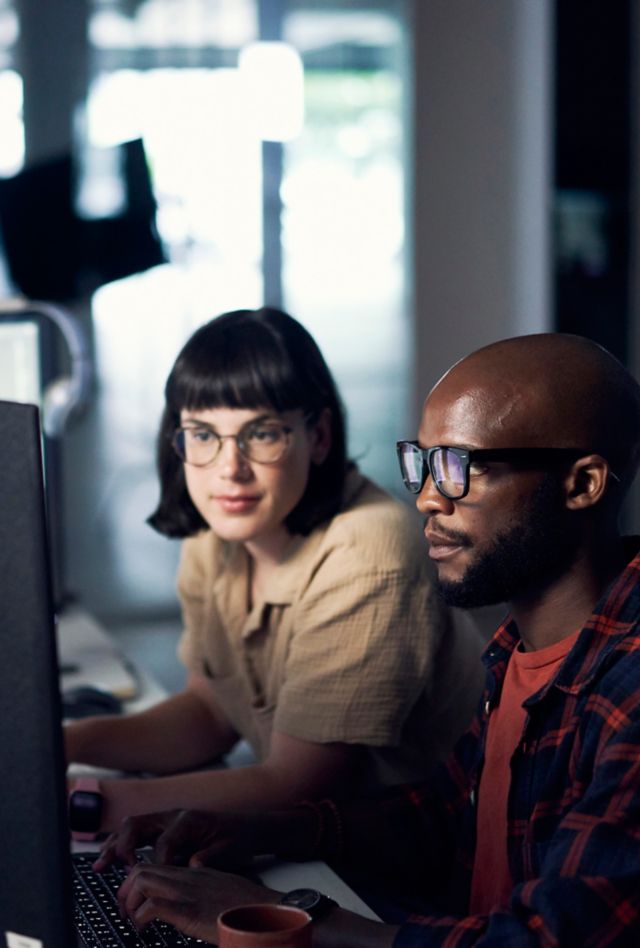 Two people looking at a computer monitor