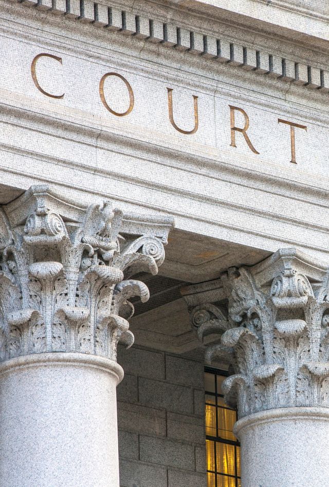 Facade of courthouse with columns.