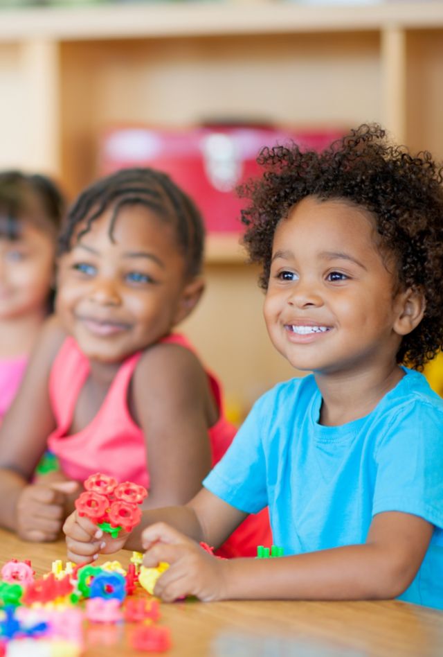 Kindergarten children playing with toys.