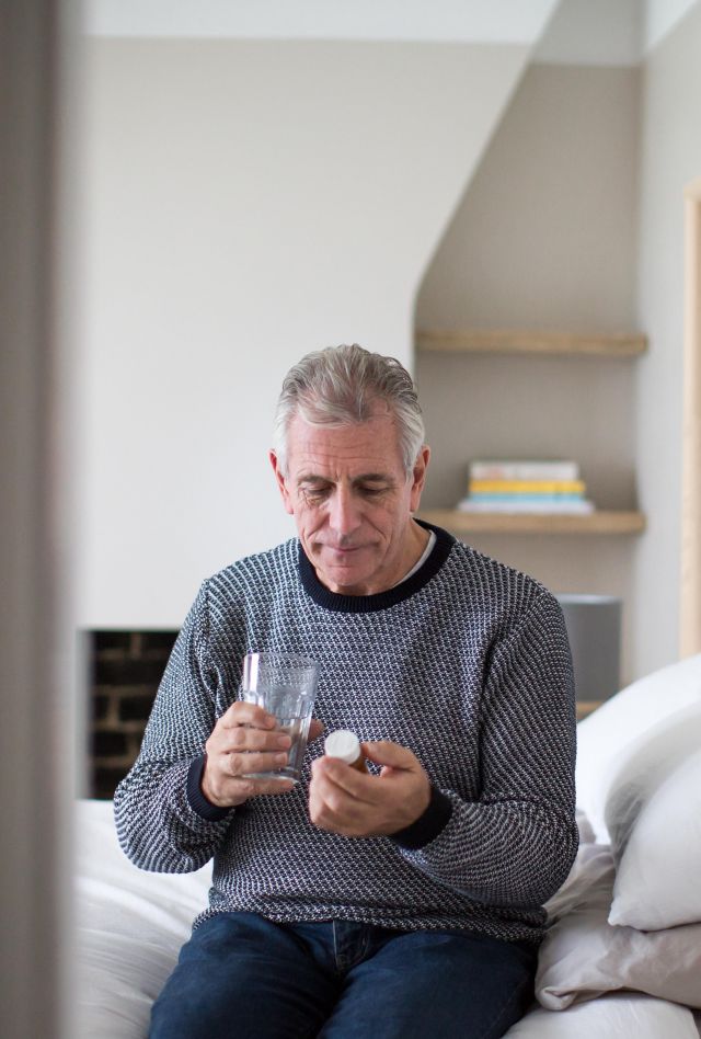 Older man taking medicine