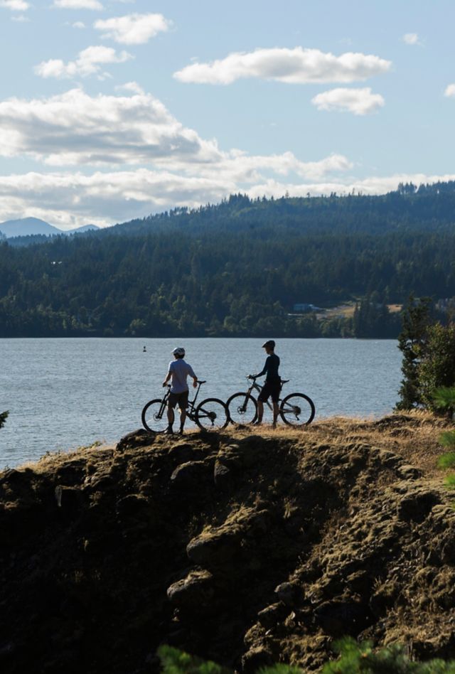 Two bikers explore Oregon near the Columbia River.