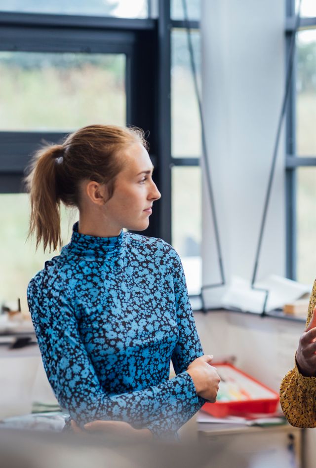 A teacher speaking to her middle school-aged students