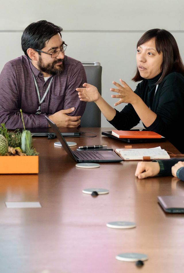 Professionals conversing around a conference room table