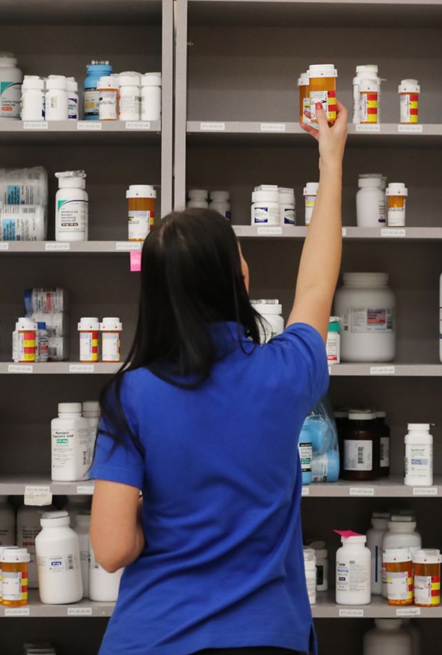 MIDVALE, UT - SEPTEMBER 10: A pharmacy technician grabs a bottle of drugs off a shelve at the central pharmacy of Intermountain Heathcare on September 10, 2018 in Midvale, Utah. IHC along with other hospitals and philanthropies are launching a nonprofit generic drug company called "Civica Rx" to help reduce cost and shortages of generic drugs.  (Photo by George Frey/Getty Images)