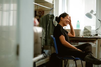 Young Filipino student sitting in her dorm room