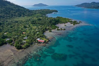 Drone shot of Chuuk Island and reef. Truk Lagoon. Ocean, coral reefs, sand, palm trees.