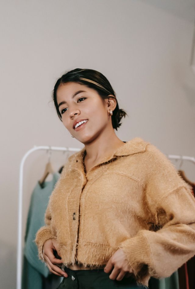 Young woman poses before a ring light